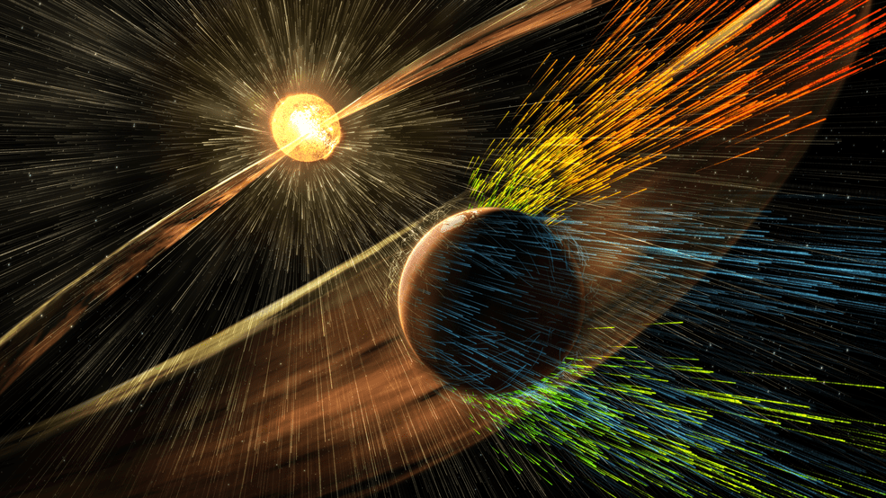 Artist’s rendering of a solar storm hitting Mars and stripping ions from the planet’s upper atmosphere. - Image Credits: NASA/GSFC