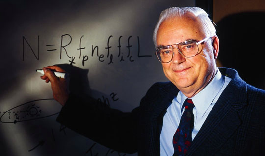 Frank Drake writing his famous equation on a white board. - Image Credit: SETI.org