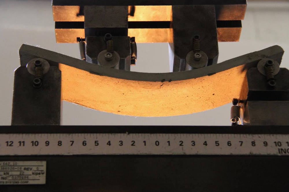 Unlike conventional concrete, engineered cementitious composite (ECC) can bend under pressure without rupturing. - Image Credit: Victor Li, CC BY-ND