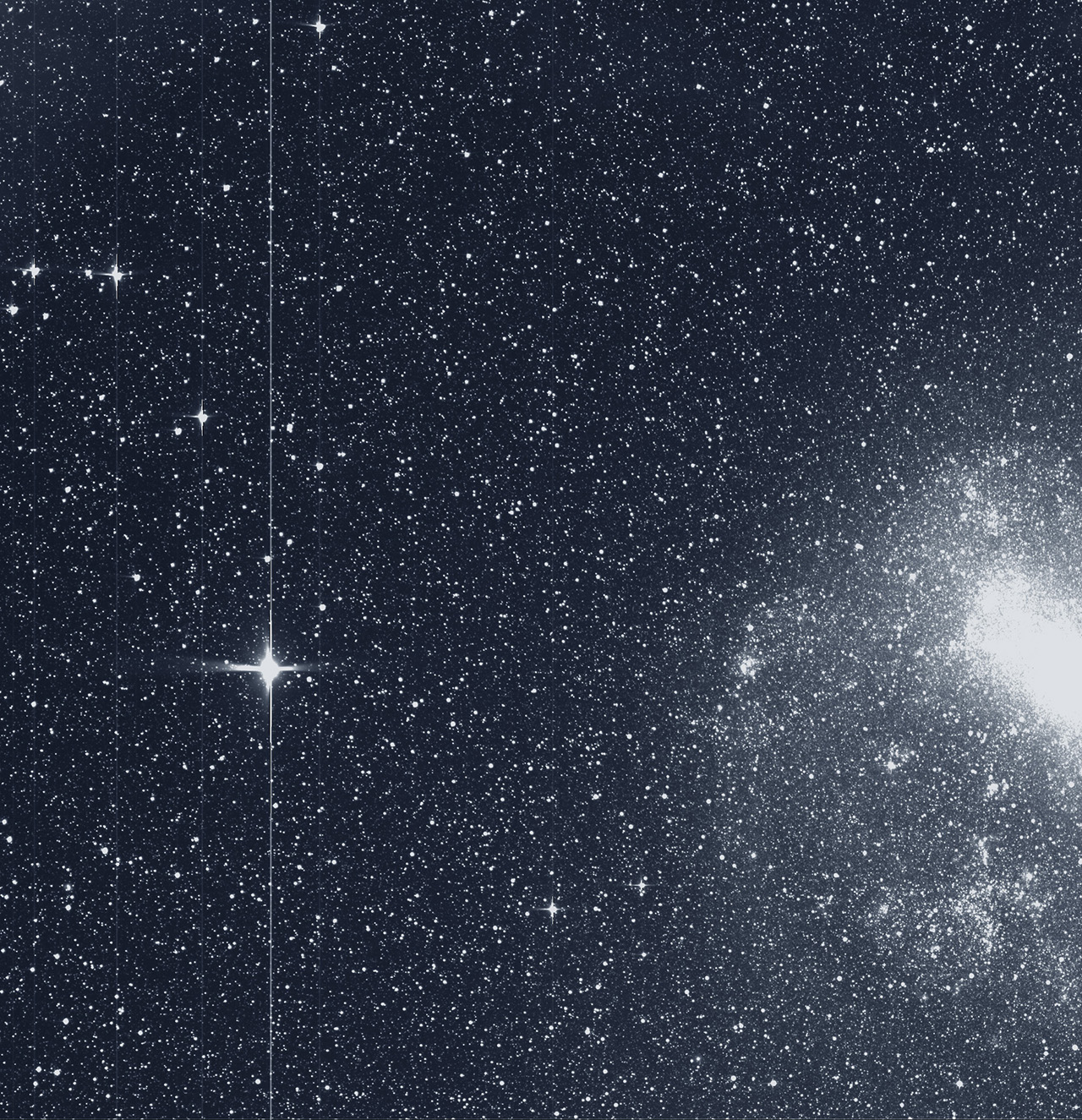The Transiting Exoplanet Survey Satellite (TESS) took this snapshot of the Large Magellanic Cloud (right) and the bright star R Doradus (left) with just a single detector of one of its cameras on Tuesday, Aug. 7. The frame is part of a swath of the southern sky TESS captured in its “first light” science image as part of its initial round of data collection. - Image Credits: NASA/MIT/TESS