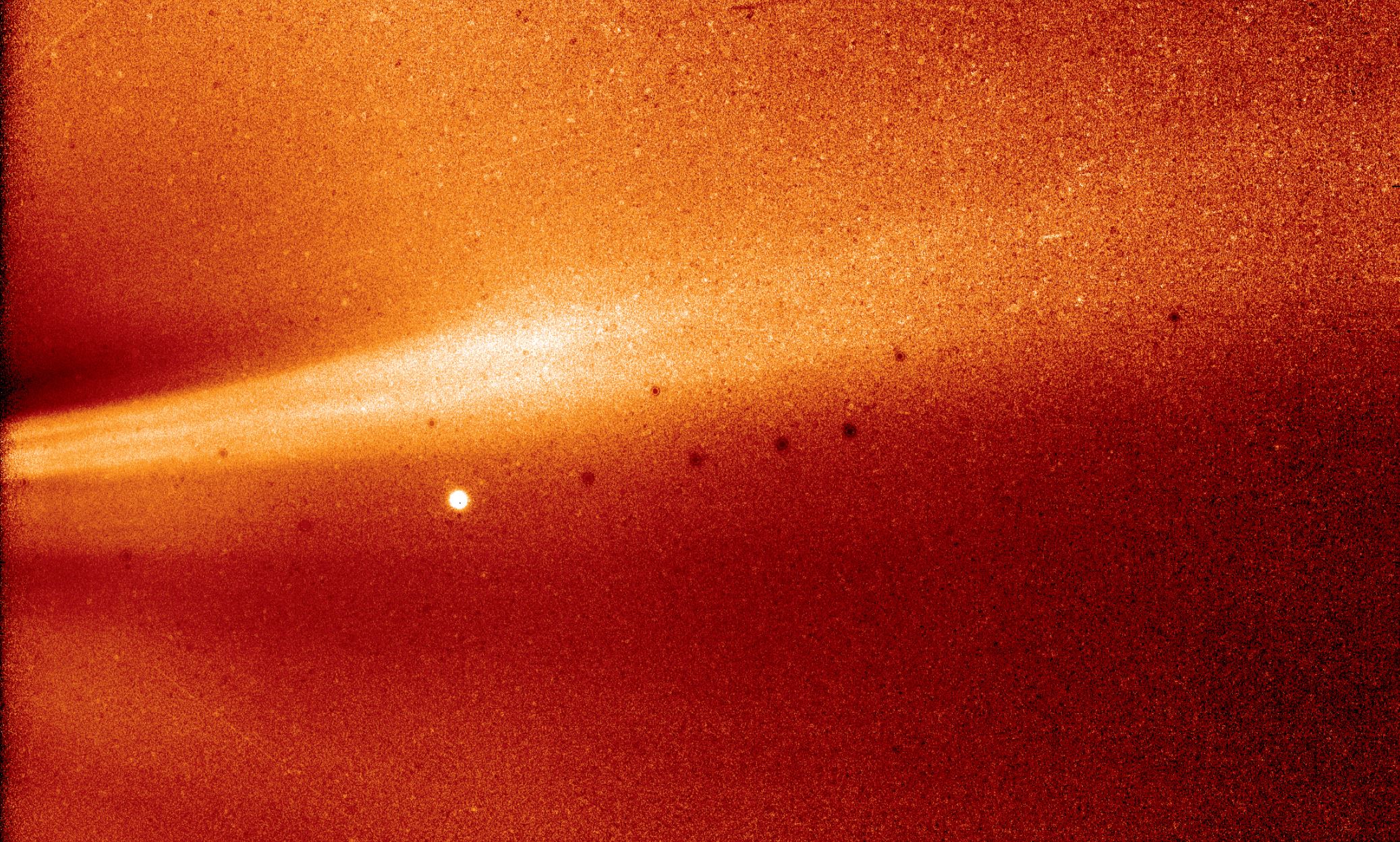 This image from Parker Solar Probe's WISPR (Wide-field Imager for Solar Probe) instrument shows a coronal streamer, seen over the east limb of the Sun on Nov. 8, 2018, at 1:12 a.m. EST. Coronal streamers are structures of solar material within the Sun's atmosphere, the corona, that usually overlie regions of increased solar activity. The fine structure of the streamer is very clear, with at least two rays visible. Parker Solar Probe was about 16.9 million miles from the Sun's surface when this image was taken. The bright object near the center of the image is Jupiter, and the dark spots are a result of background correction. - Image Credits: NASA/Naval Research Laboratory/Parker Solar Probe