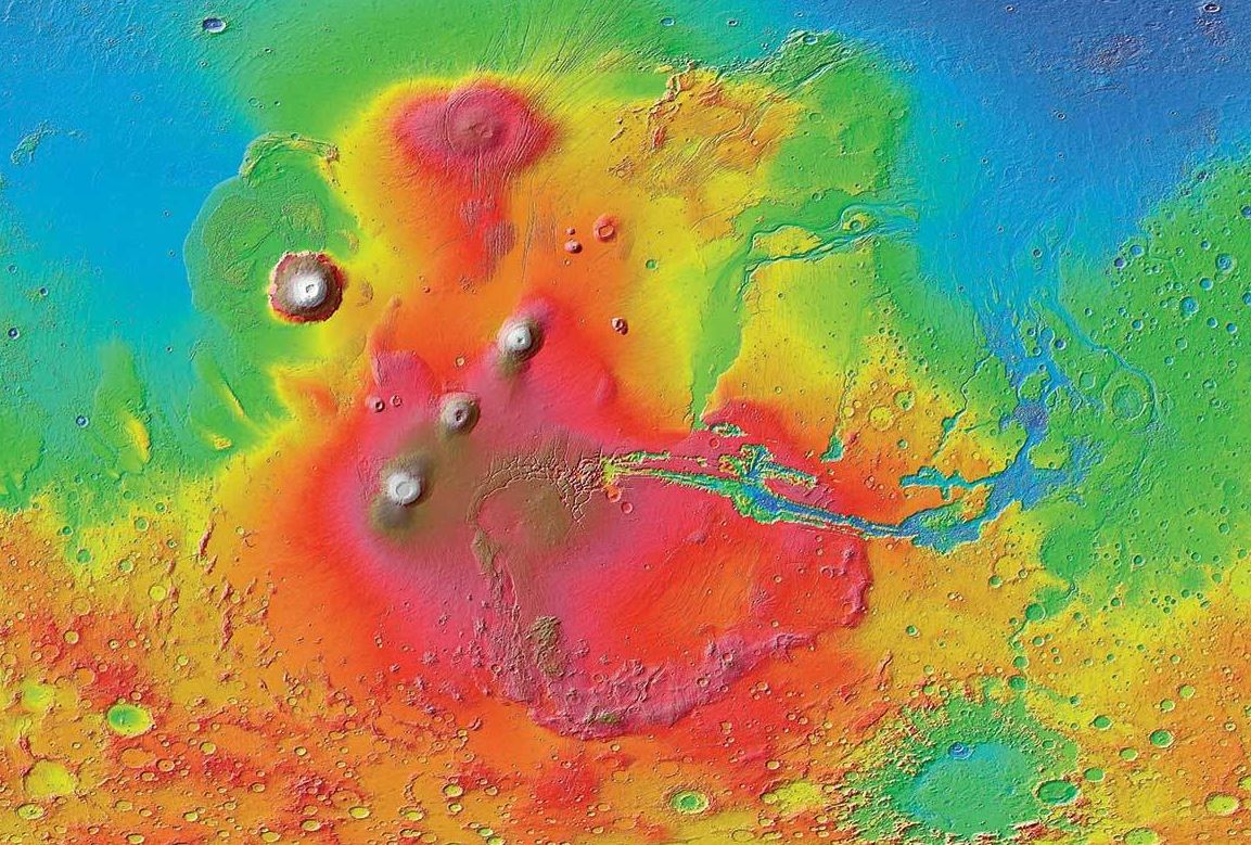 A colorized image of the surface of Mars taken by the Mars Reconnaissance Orbiter. The line of three volcanoes is the Tharsis Montes, with Olympus Mons to the northwest. Valles Marineris is to the east. - Image Credit: NASA/JPL-Caltech/ Arizona State University