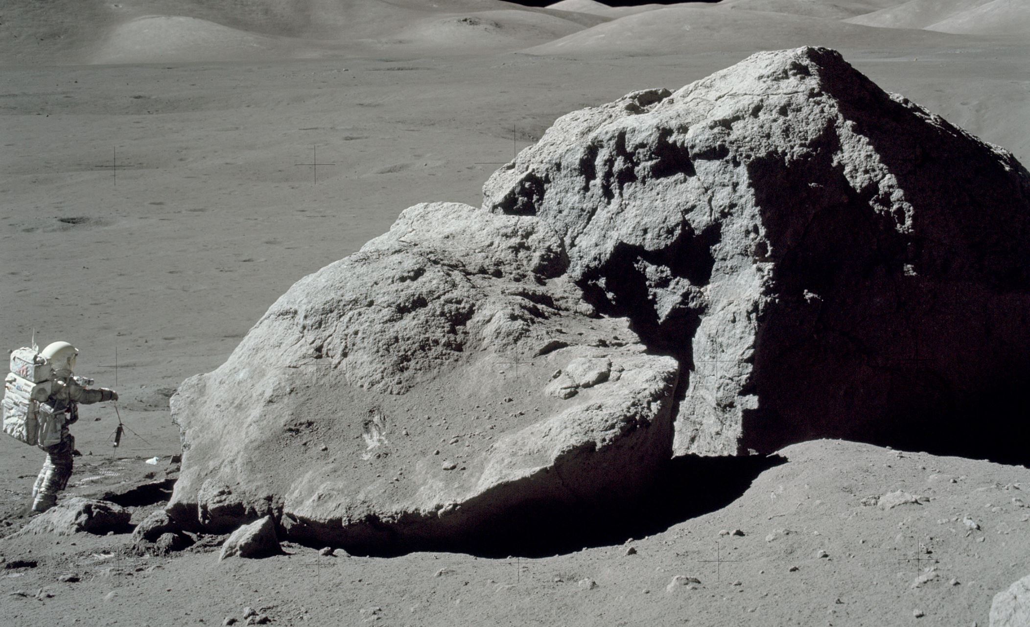 Apollo 17 astronaut Harrison H. Schmitt standing beside a boulder on the lunar surface. - Image Credit: NASA