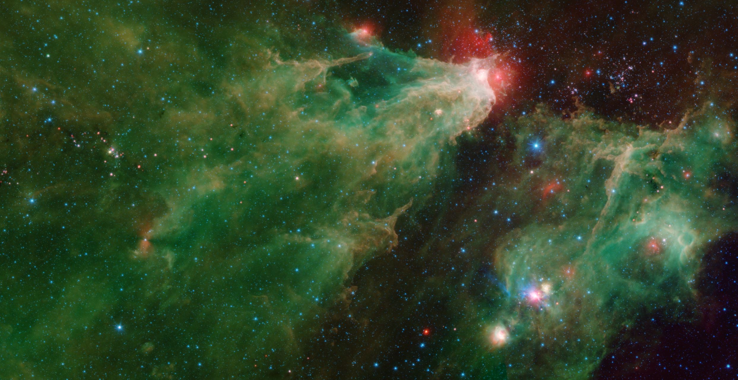 A mosaic by NASA's Spitzer Space Telescope of the Cepheus C and Cepheus B regions. This image combines data from Spitzer's IRAC and MIPS instruments. - Image Credit: Credits: NASA/JPL-Caltech