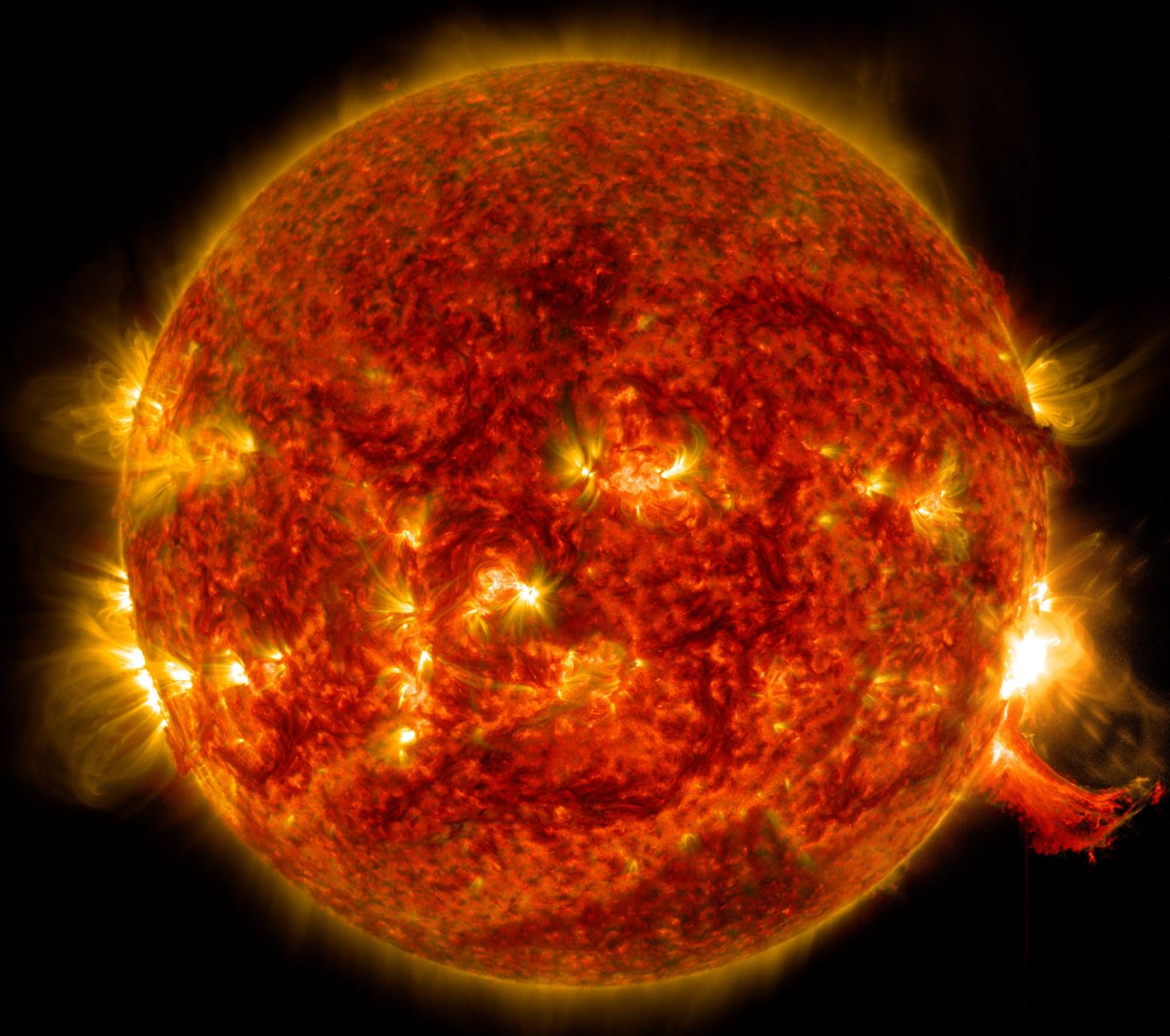 NASA's Solar Dynamics Observatory captured this image of a solar flare on Oct. 2, 2014. The solar flare is the bright flash of light on the right limb of the Sun. A burst of solar material erupting out into space can be seen just below it. - Image C…