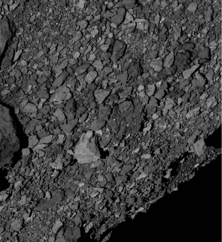 OSIRIS-REx found that Bennu’s surface is unexpectedly rocky. The large light-colored rock in the center is about 7.4 meters (24 ft.) wide. That’s about half the width of a basketball court. This image was captured by the spacecraft’s PolyCam camera. - Image Credits: NASA/Goddard/University of Arizona