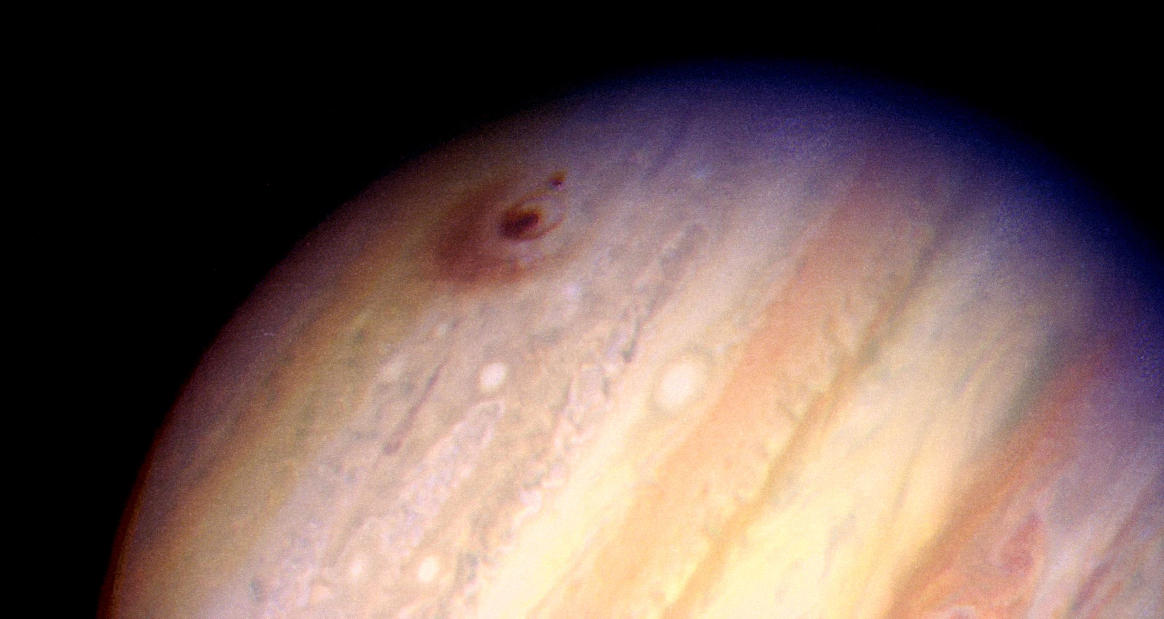 This image of the giant planet Jupiter, by NASA's Hubble Space Telescope, reveals the impact sites of fragments "D" and "G" from Comet Shoemaker-Levy 9. The large feature was created by the impact of fragment "G" on July 18, 1994 at 3:28 a.m. EDT. It entered Jupiter's atmosphere from the south at a 45-degree angle, and the resulting ejecta appears to have been thrown back along that direction. The smaller feature to the left of the fragment "G" impact site was created on July 17, 1994, at 7:45 a.m. EDT by the impact of fragment "D". - Image Credit: H. Hammel, MIT and NASA