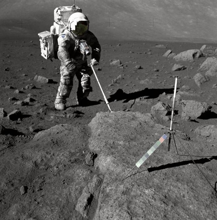 Harrison Schmitt trying to collect moon rock. - Image Credit: NASA