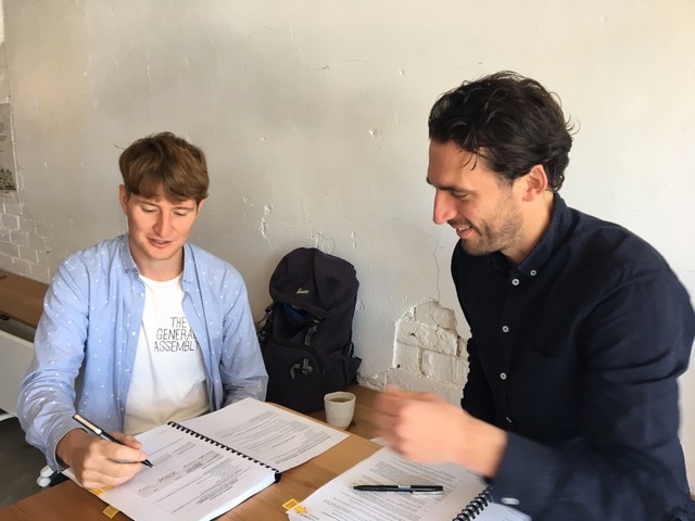 Marcelo and Liam (Founding Director, HIP V. HYPE) signing contracts