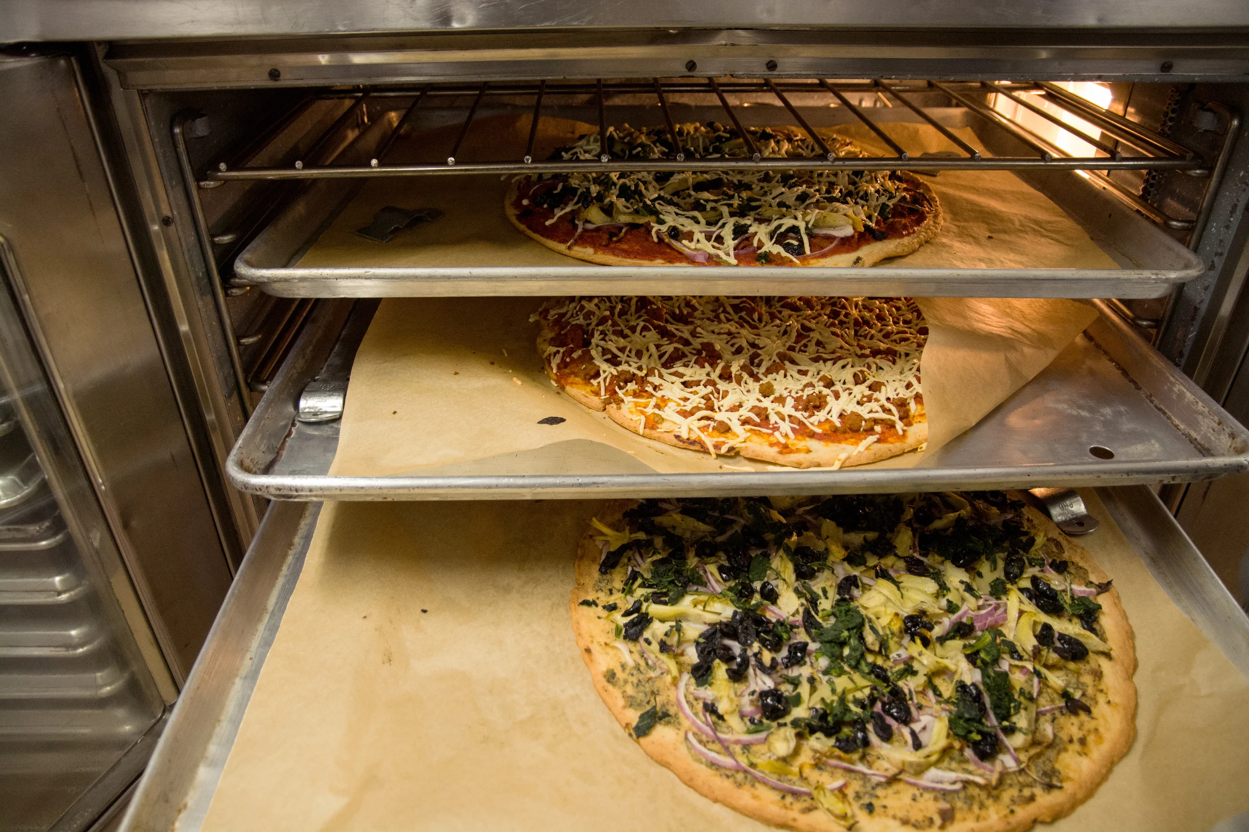 A delicious lunch of vegan, gluten-free pizza, made in Earthly Gourmet's on-stie commercial kitchen which houses the headquarters of gluten-free bakery Sift . All ingredients on the pizzas are ones that Earthly Gourmet distribute. 