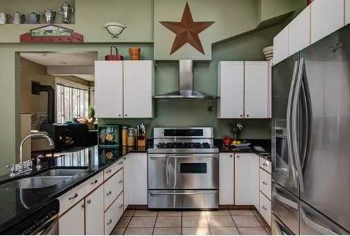 The kitchen of a home staged by D Organizing .