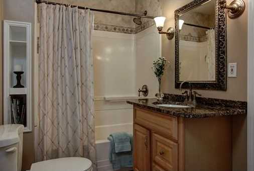 The bathroom of a home staged by D Organizing .