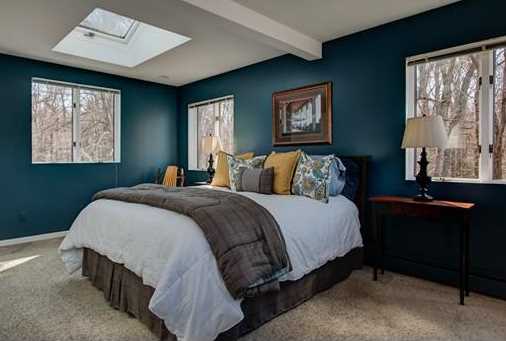 The bedroom of a home staged by D Organizing .