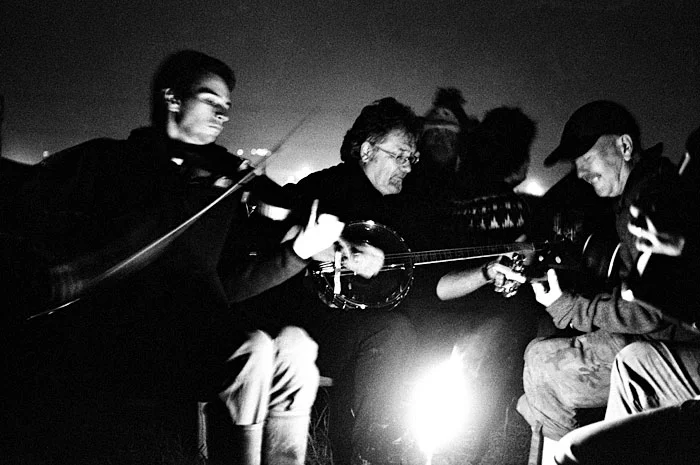 Folk music being played around the camp fire. STUNICGLAST006