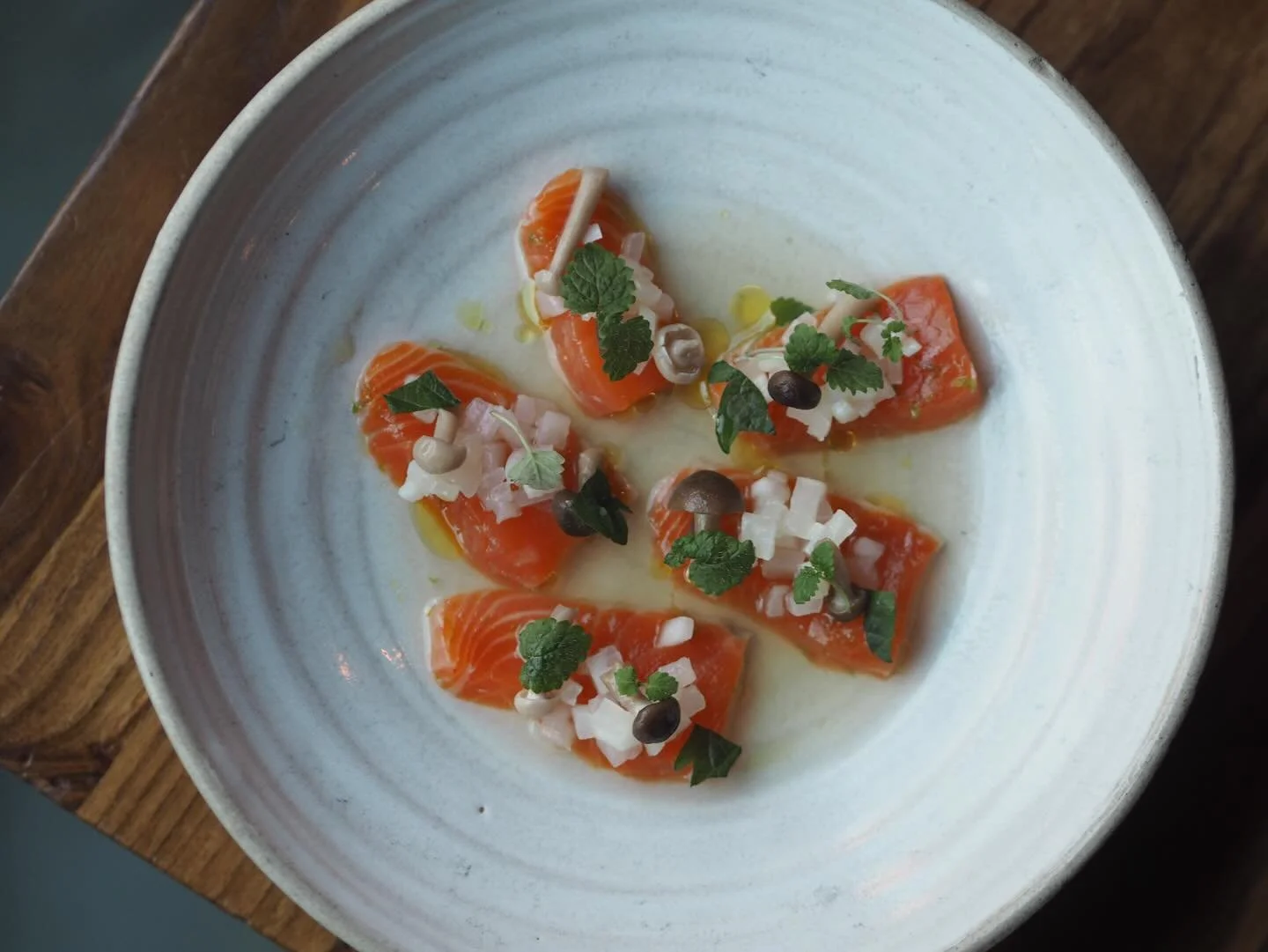 TROUT CRUDO, APPLE DASHI
@chefthomlemercier 

Taken from a bee&rsquo;s private jet x