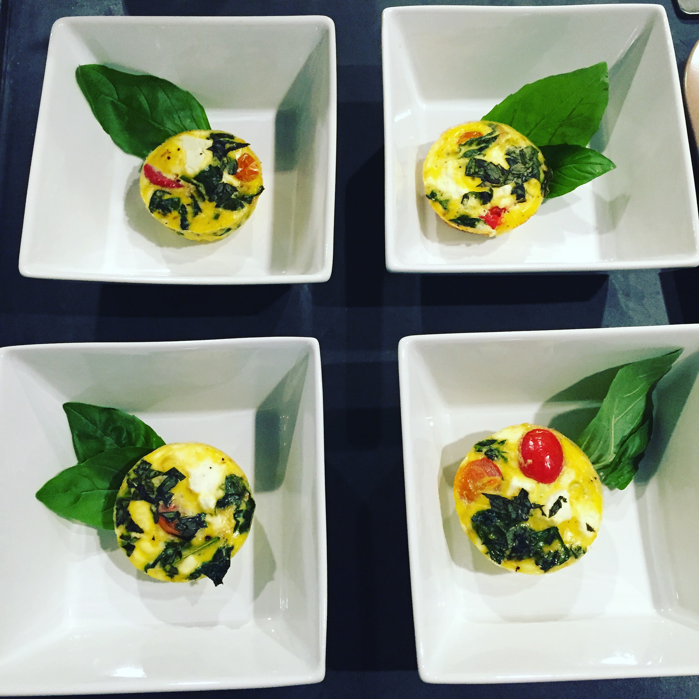 Veggie Egg Cups, garnished with fresh basil, as plated for the Om to Yum event at the Easton Public Market. 