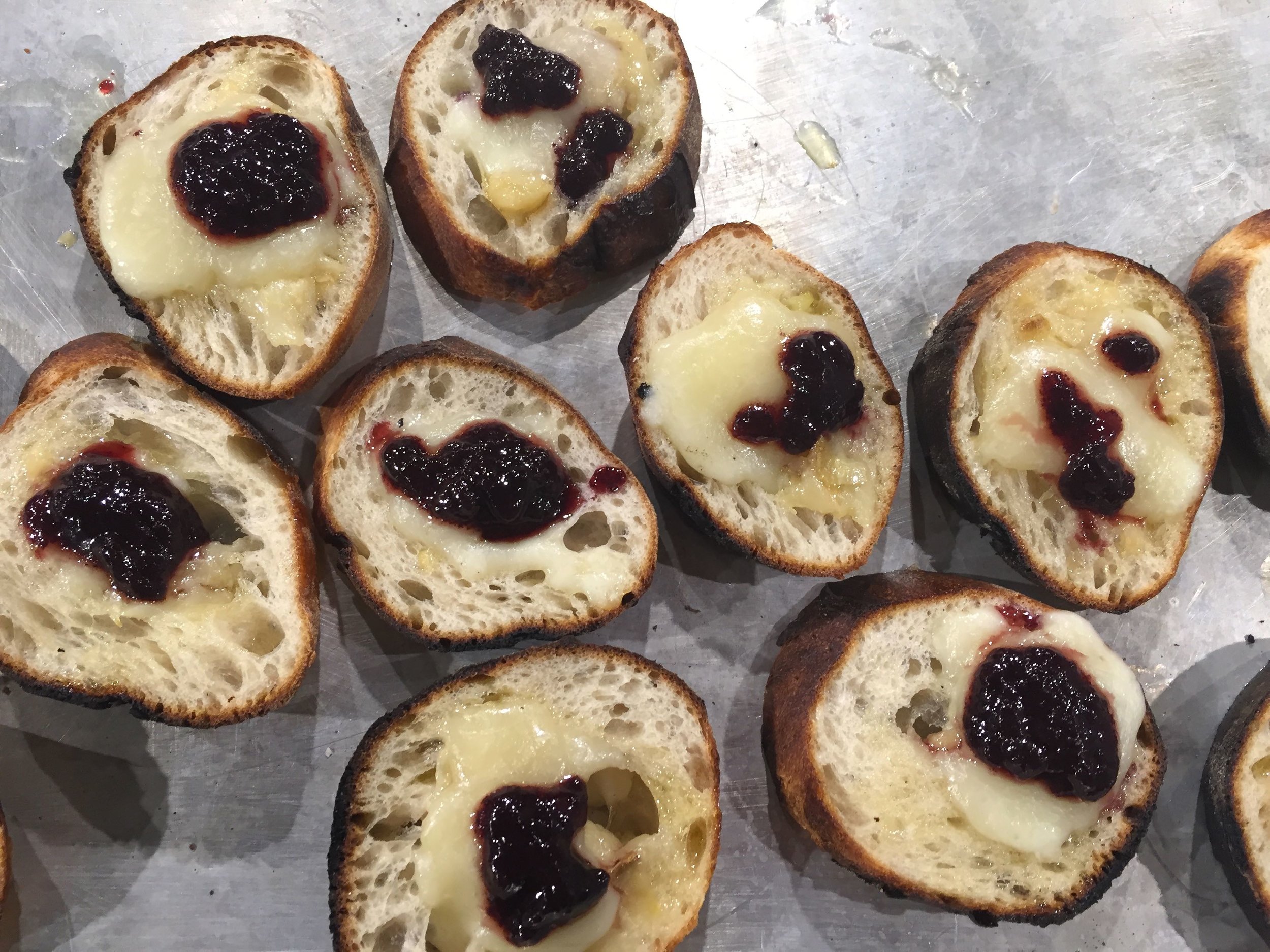 Garlic confit smeared on baguettes toasted with Tavoliere cheese and Eat This! Blackberry-Rosemary jam. 