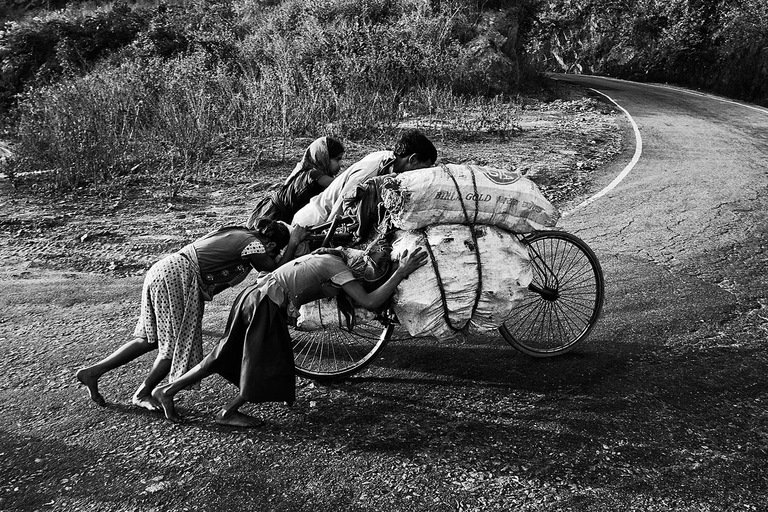 Jharia Mining - A whole family pushes a bicycle full of coal