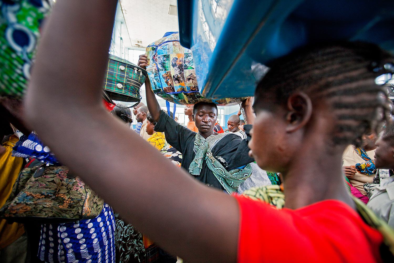 Tazara Express - A man loads a heavy pack on his head before leaving the station. Zambia