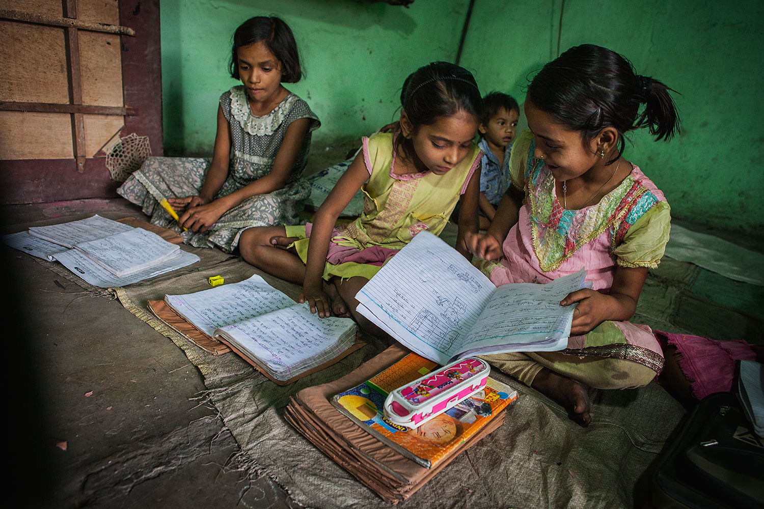 Three Indian children play homework after school. Bokaro- India
