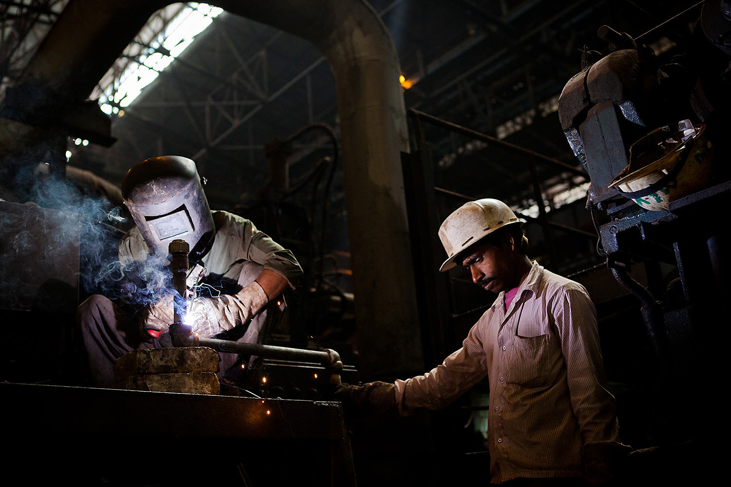 Two men working in a steel center in Bokaro- India