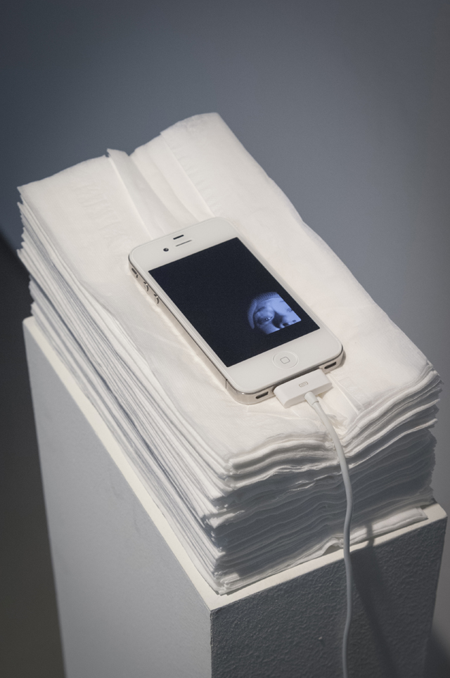 I Left My Wallet In Cupertino, 2013. Pedestal, stack of tissues, iPhone 4s with charger, and looping video.
