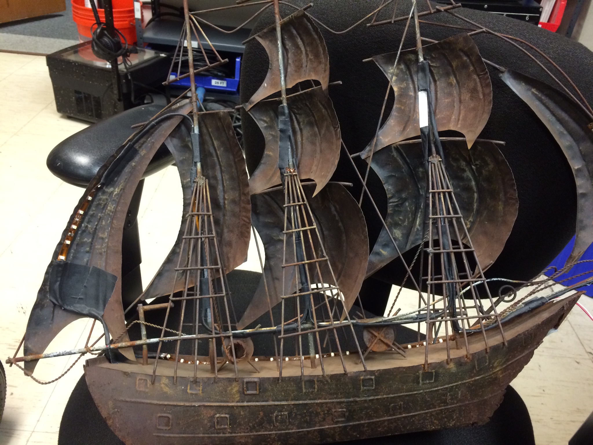 I soldered and wired LED tape along the back of the ship, hiding the light source from the audience and working as a portable source of uplight for Prospera. 
