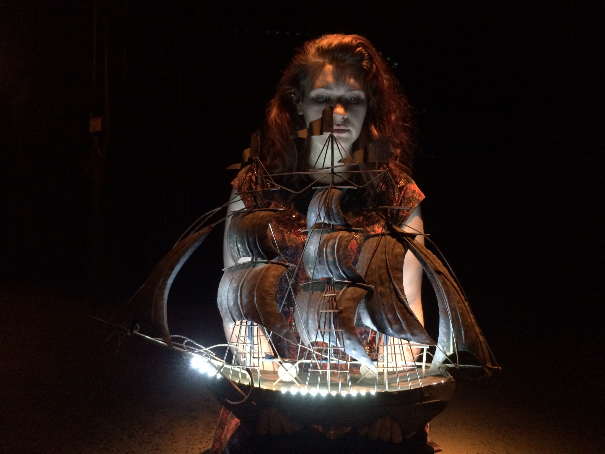 Abigail Phelps (Prospera) holding the finished ship in the first moment of the play.