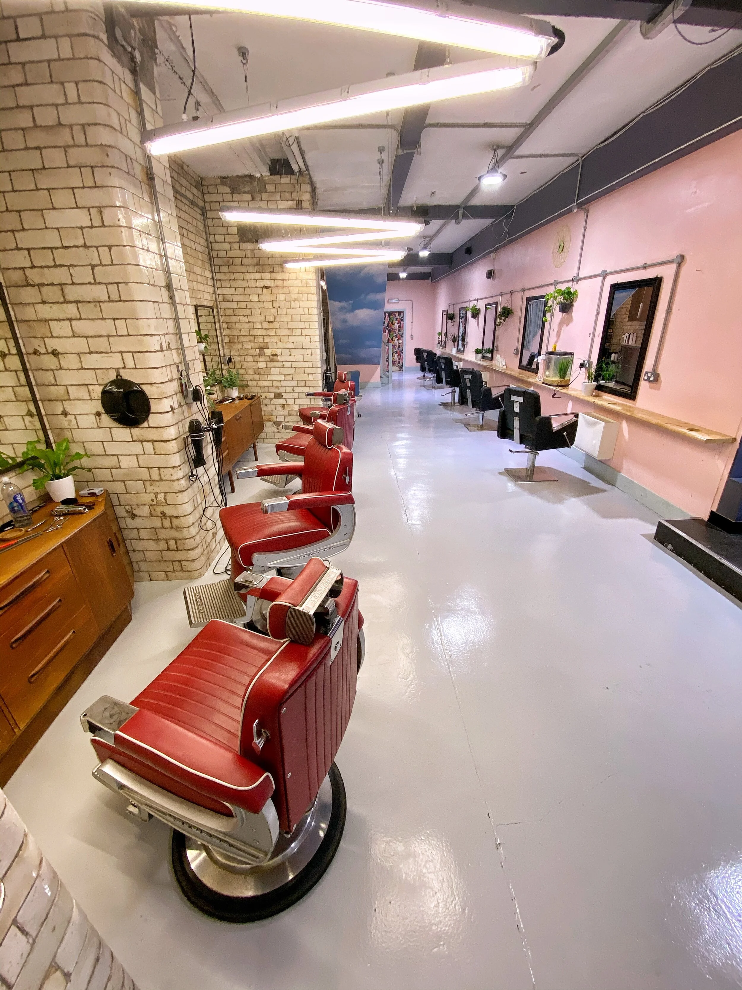  At Barber Below we do things differently. Based 18 feet underground in the Northern Quarter and only accessible through a hair salon (RCNQ) we have created a space larger than life. Our Speakeasy barbers is an attitude-free environment where you can