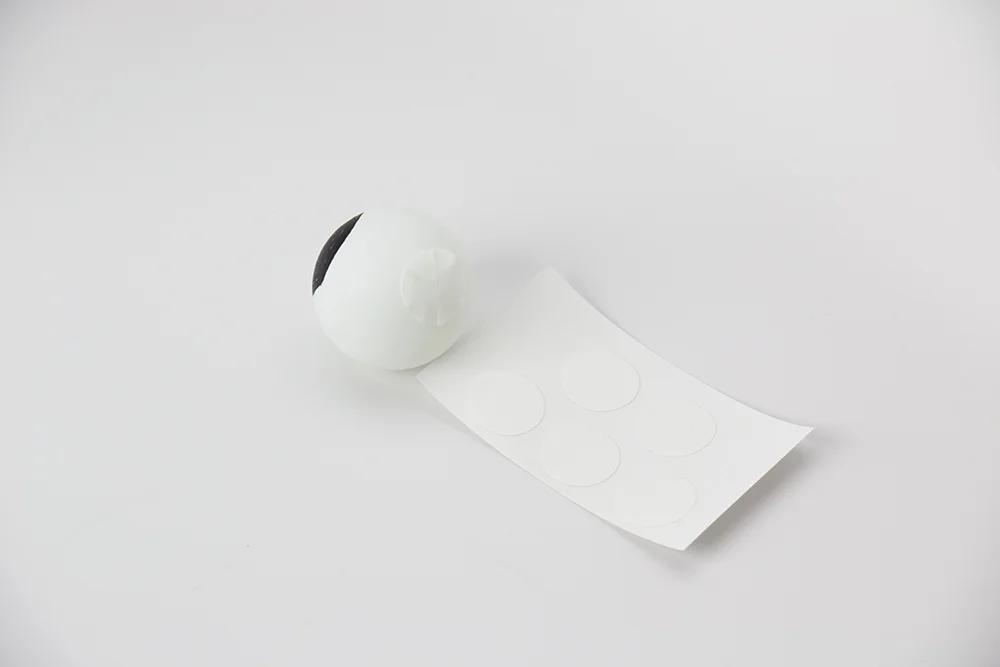 Peel off one Fearless Tape Do t from the sheet and place it on a googly eye.