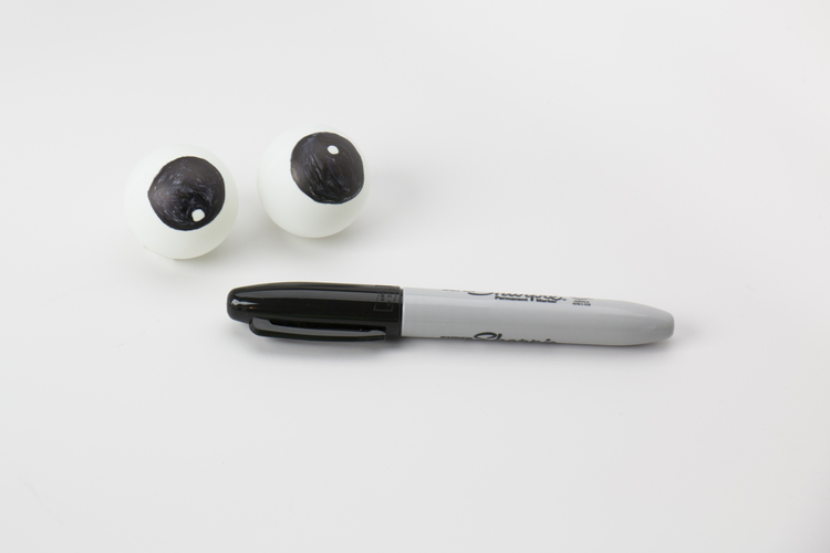 Take the ping pong balls and draw googly eyes on them. 