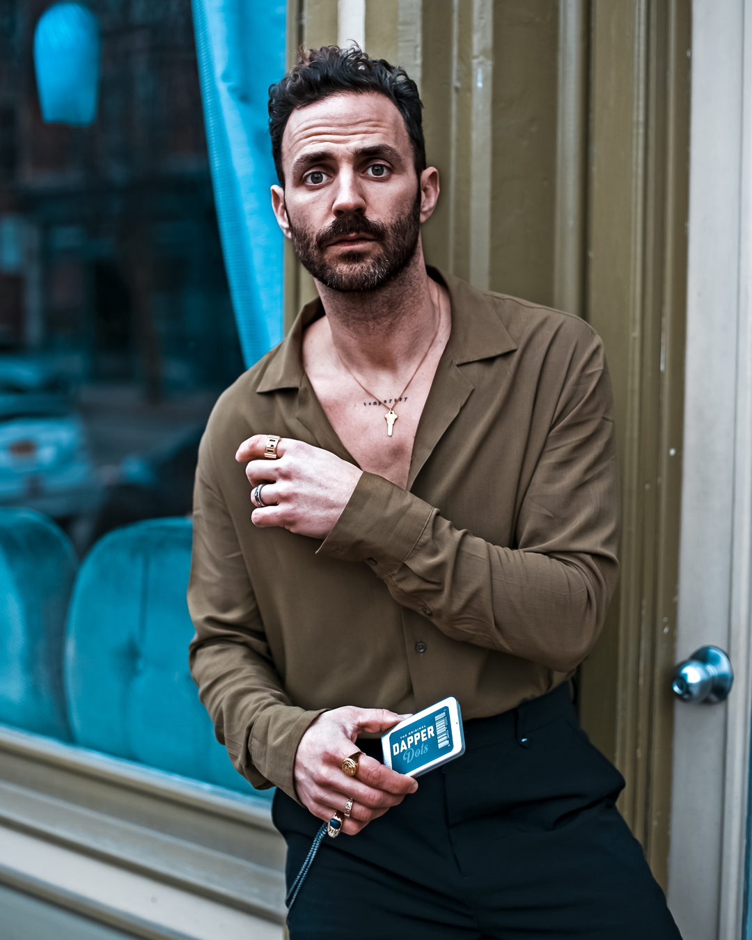 Eric Wertz poses for the camera, holding a pack of fearless tape Dapper Dots 