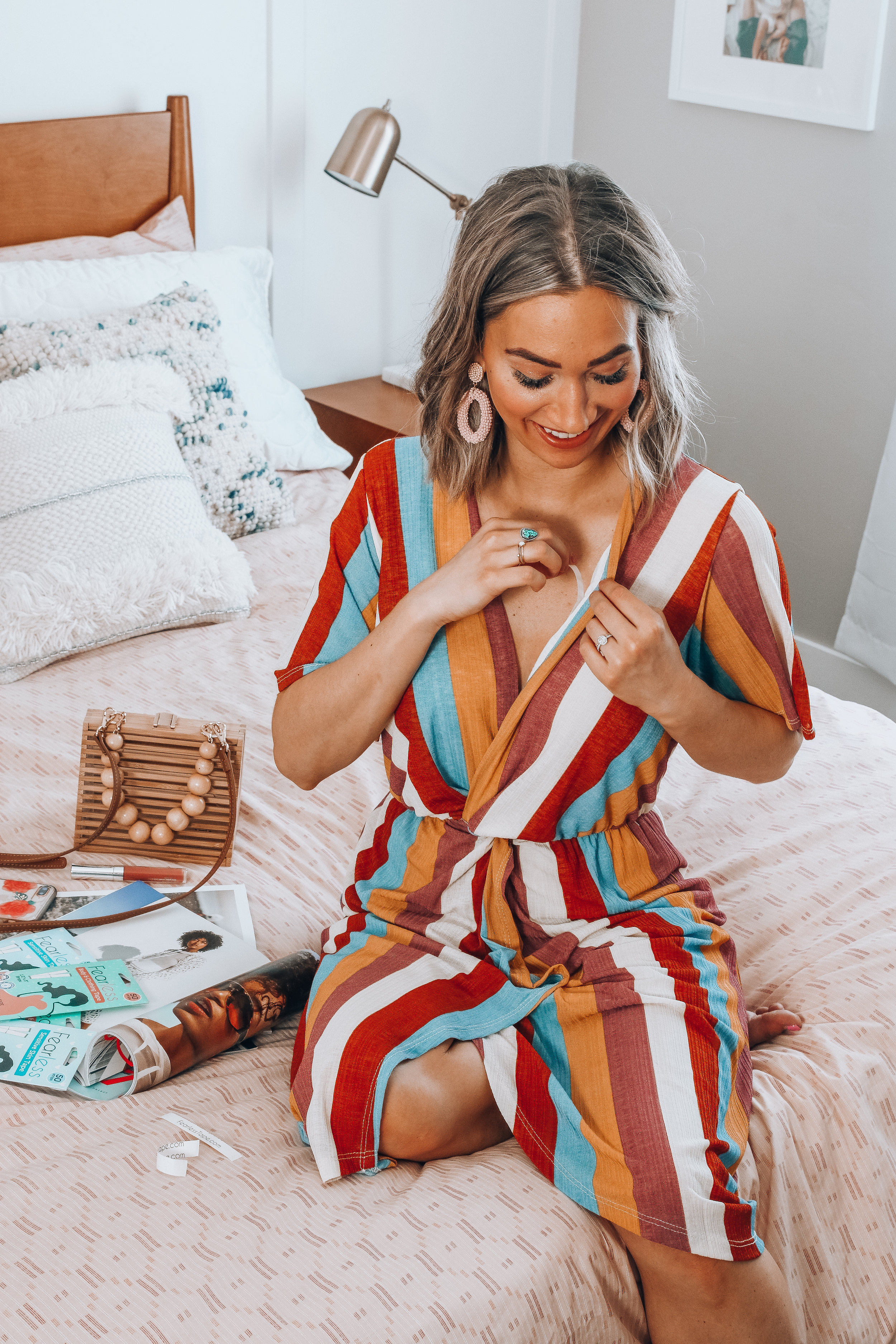 Karlee Andrews easily removes a strip of fearless fashion tape from her dress neckline