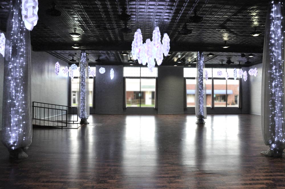 Custom Color LED ceiling fixture lighting in 16 different color choices. The white lights on the columns stay white. This room can seat up to 200 people. 23 - 60" round tables with 8-9 chairs around each table