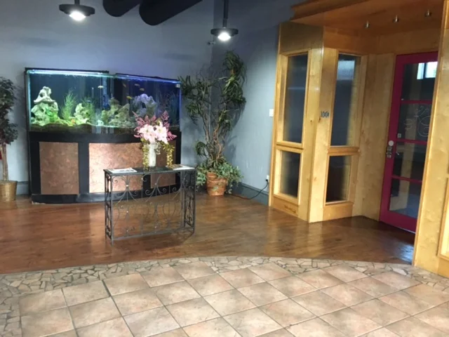 Venue Entrance with 650 gallon fish tank. To the right is the small venue through the pink door