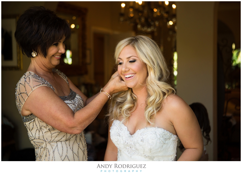 Mother of the bride helping her daughter get ready