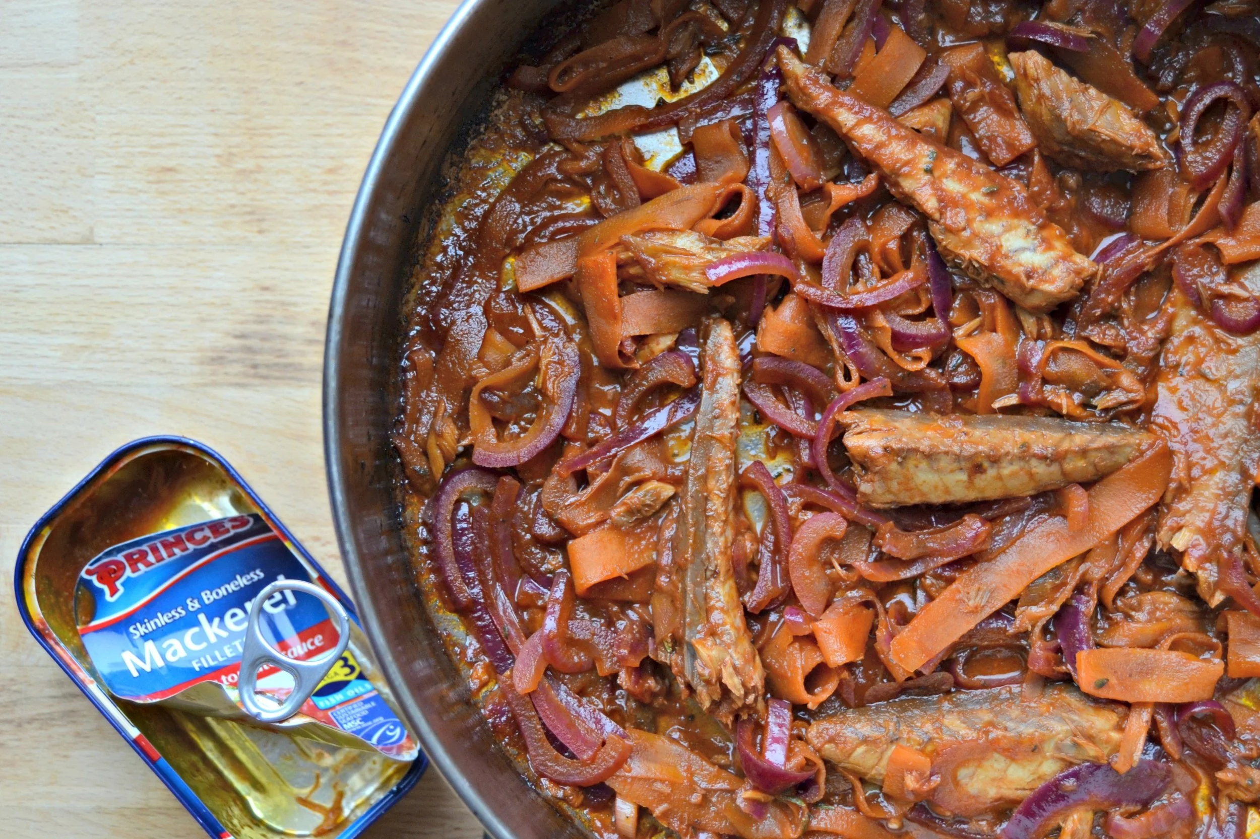 6. Stir gently so the sauce coats all the ingredients without breaking up the mackerel fillets. Cook for a further 1-2 minutes until the fish is warmed through.