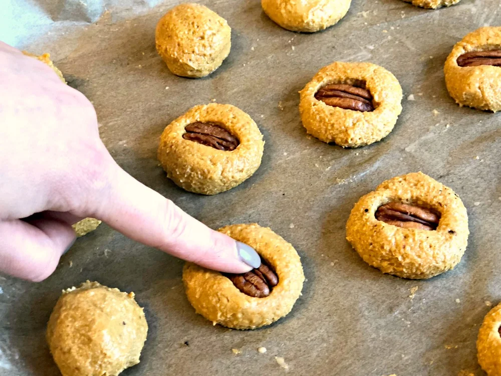 Gluten free vegan sweet potato cookies topped with pecan nuts.jpg