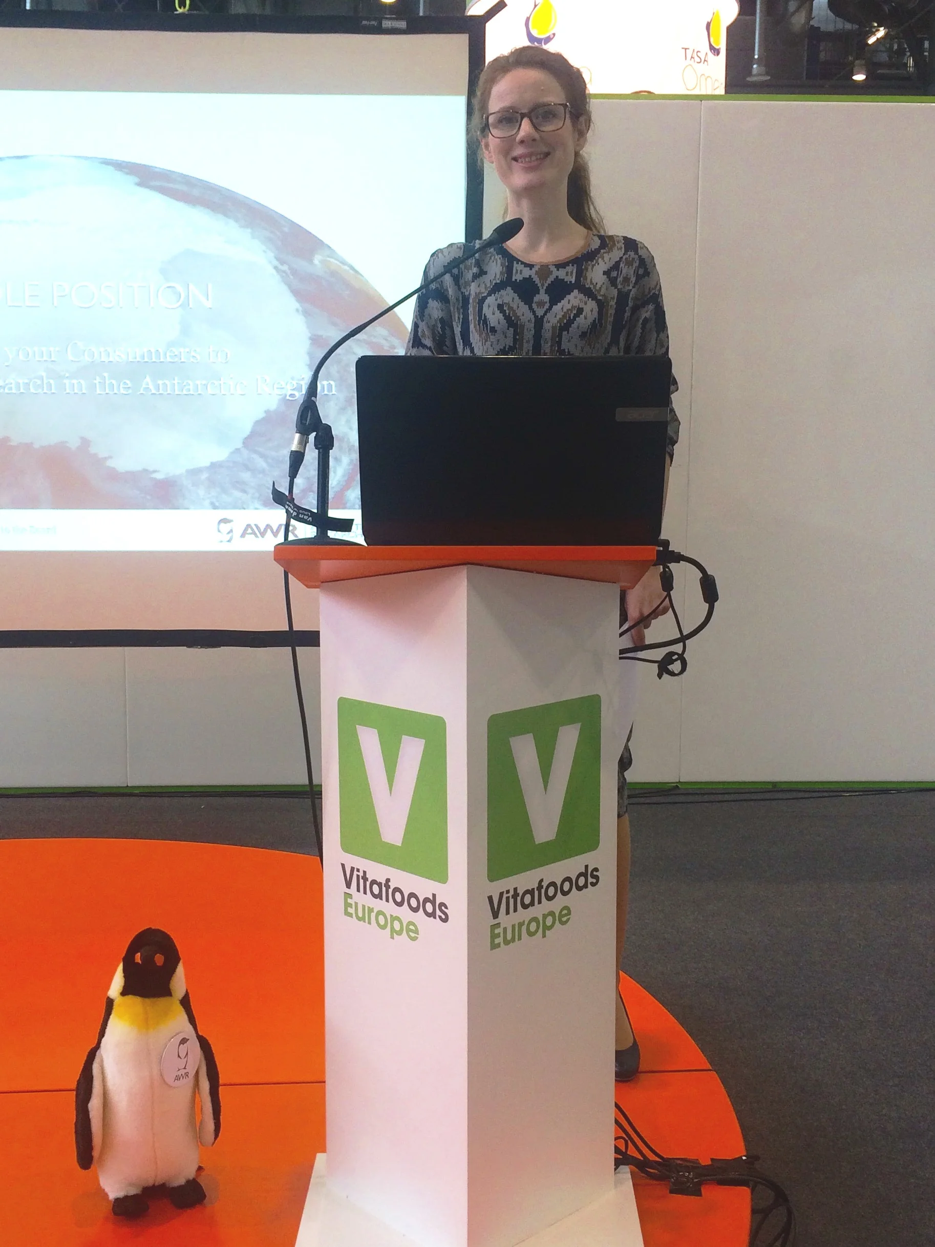Marte Grindaker and the AWR Penguin presenting the Antarctic Wildlife Research Fund.