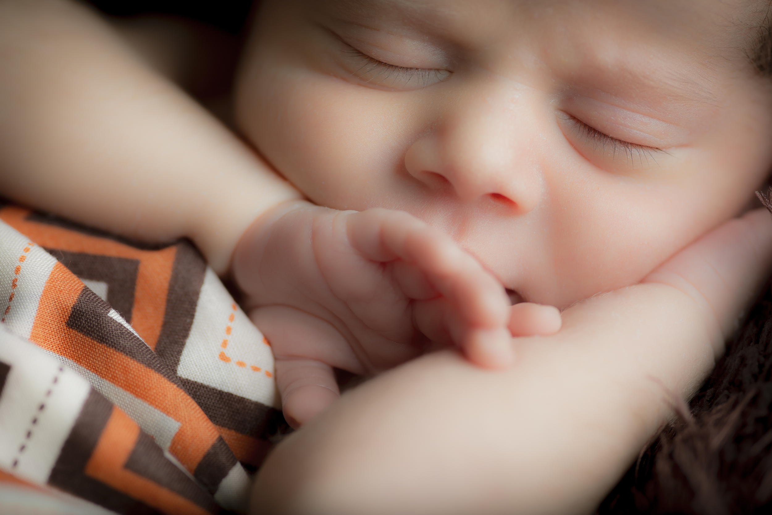 42 modern newborn boy photography swaddled in chevron close hands studio session.jpg