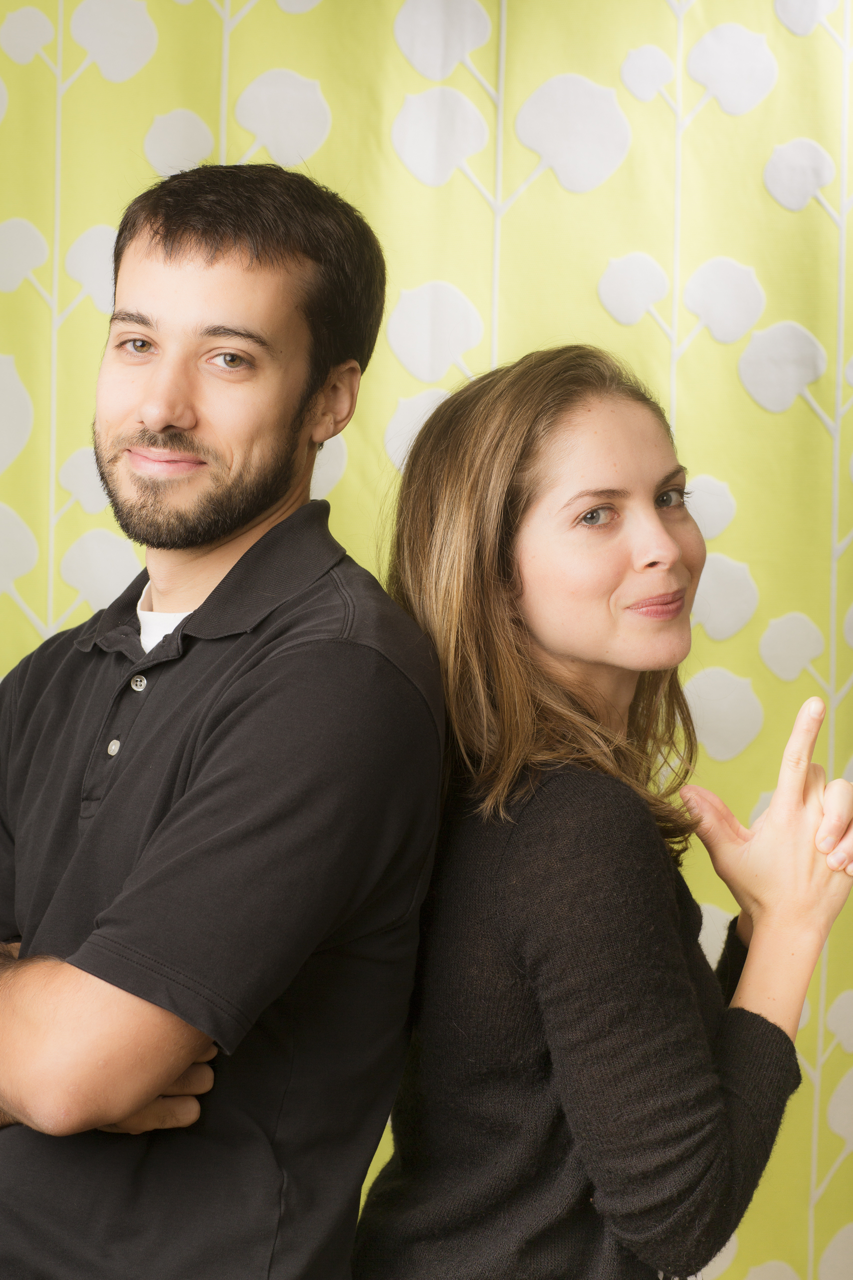 28 young couple family portrait studio session on fun green background.jpg