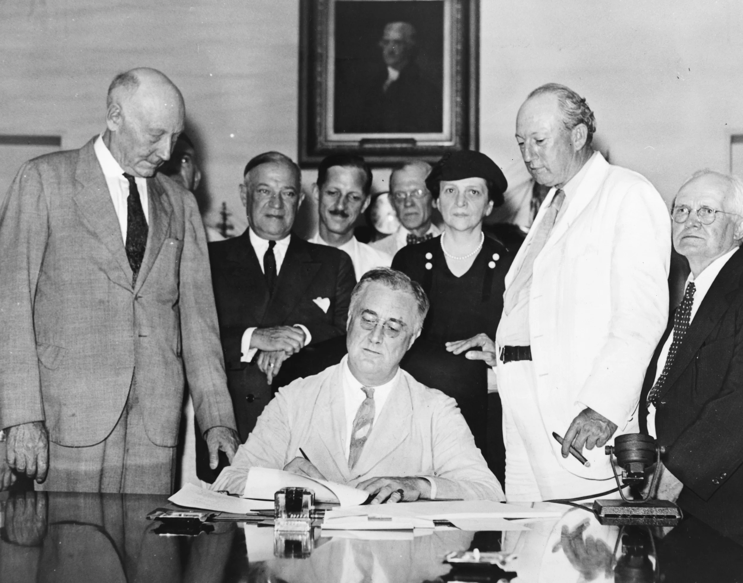 Secretary of Labor Frances Perkins, the only woman present as Roosevelt signed the Social Security Act in 1935. LOC