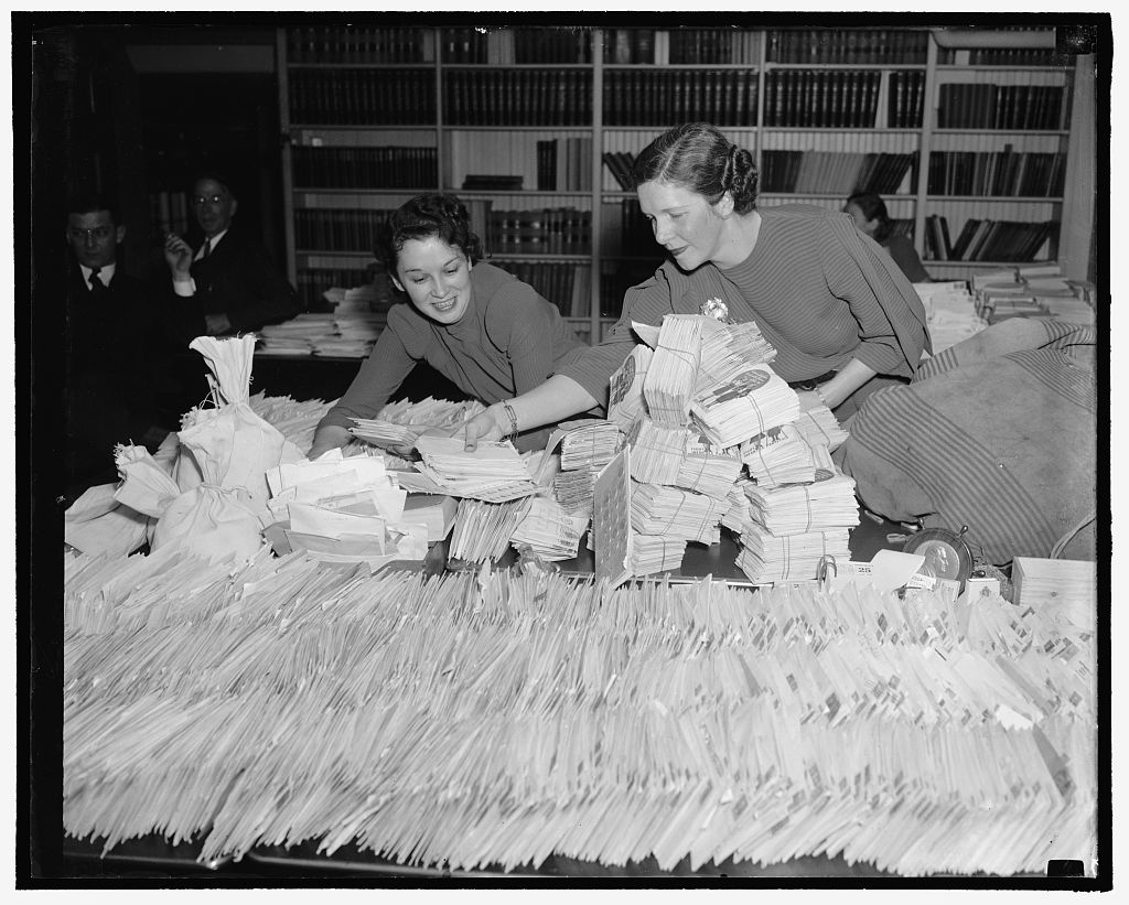 Barbara Councilor and Ethel Haberkorn, Workers in the White House Mail Room, attempting to keep up with the flood of dimes which are coming to the President's Birthday Ball Committee to add to the fund to right infantile paralysis. Courtesy, LOC