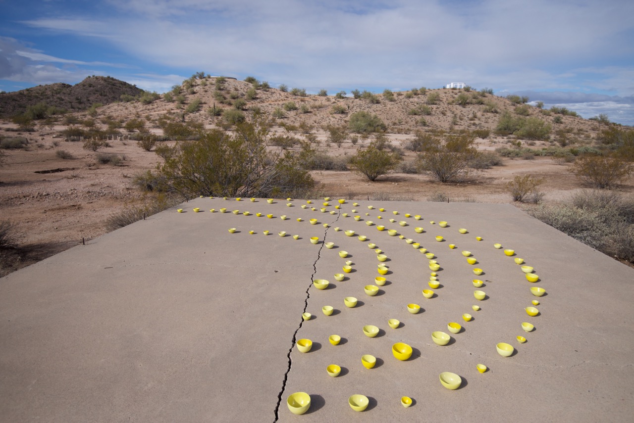 Gila River. In the distance you can see the original water tank on the left on the top of the knoll and the Monument on the left built by the internees in 1944. I placed the bowls on the cement foot print of what was the school.
