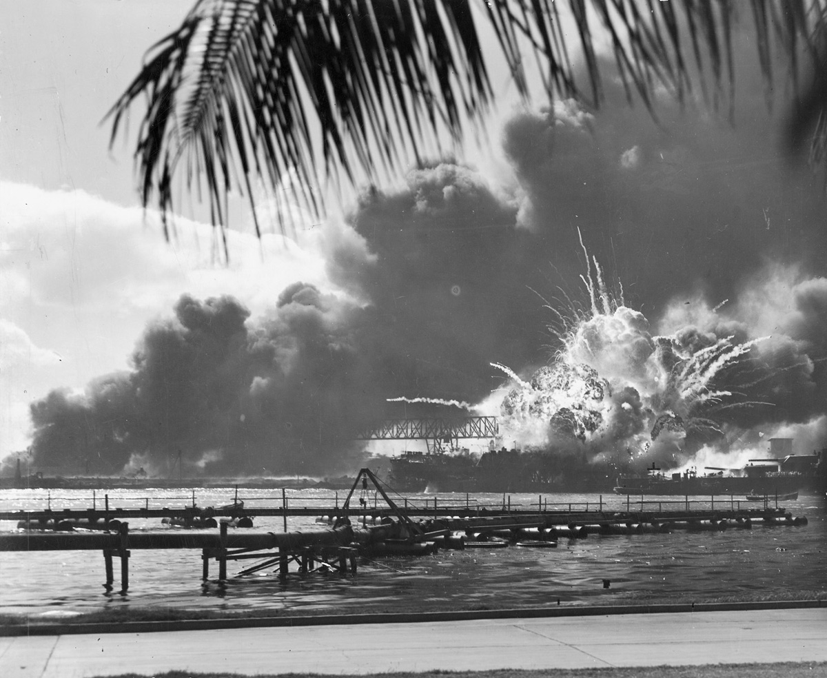 The USS Shaw explodes under Japanese attack the morning of December 7, 1941, in the waters of Pearl Harbor.