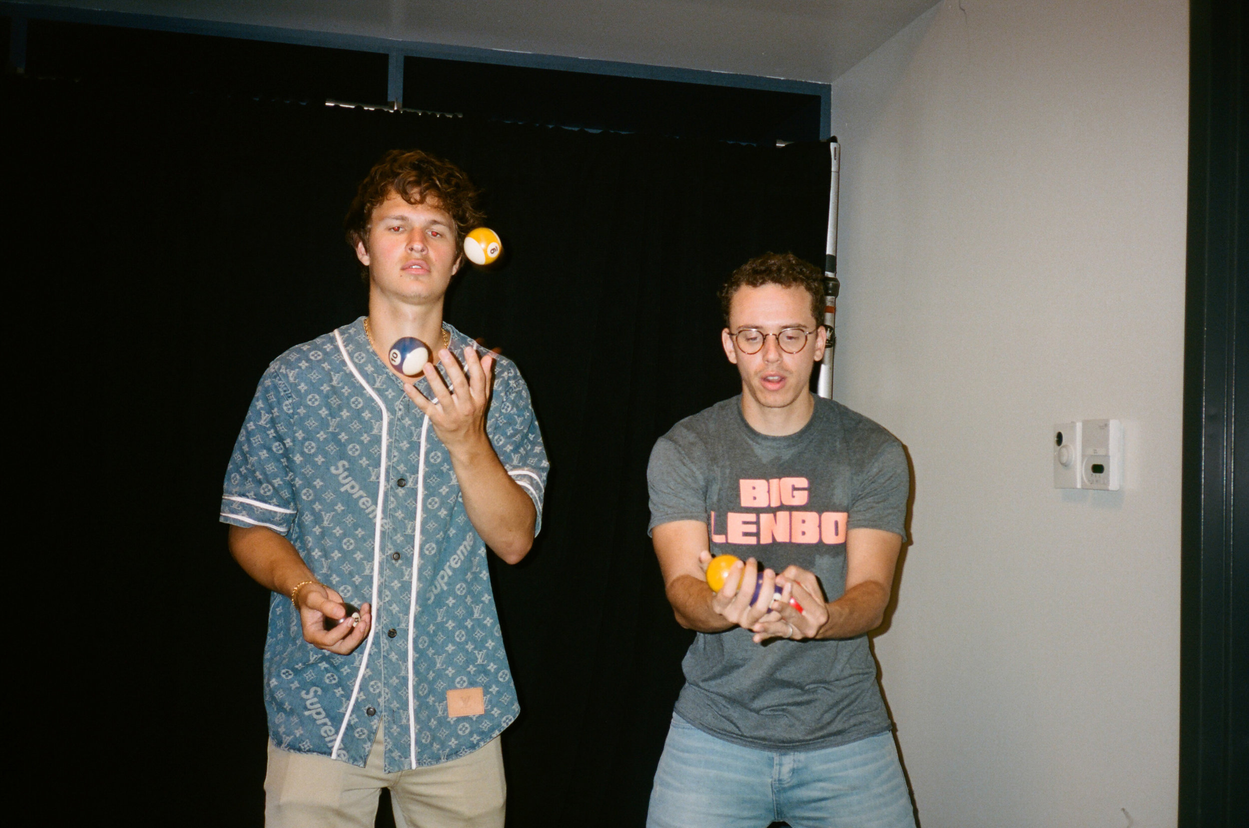 Ansel Elgort and Bob try and juggle pool balls.