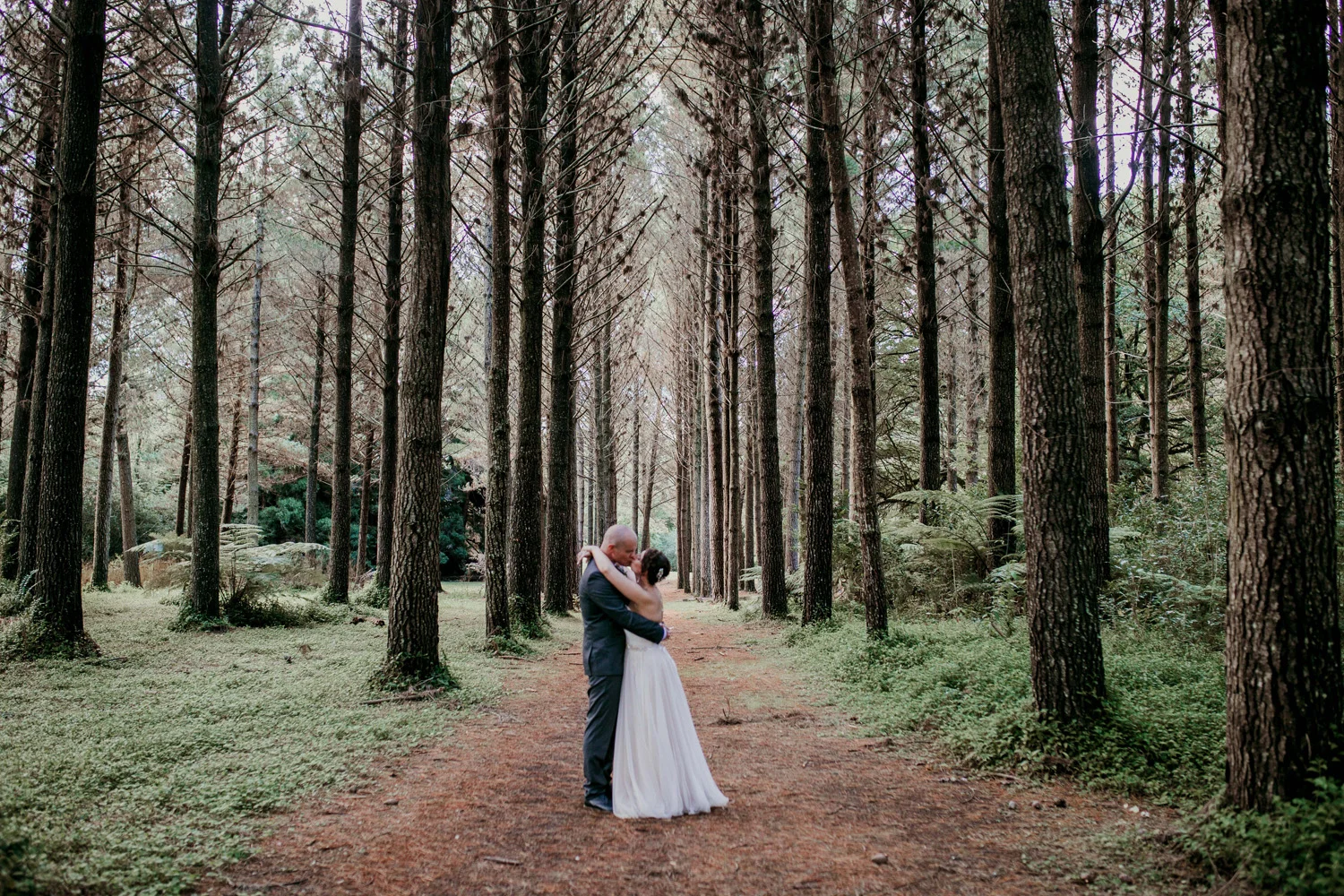 Bride and groom in the woods at Hunua Falls