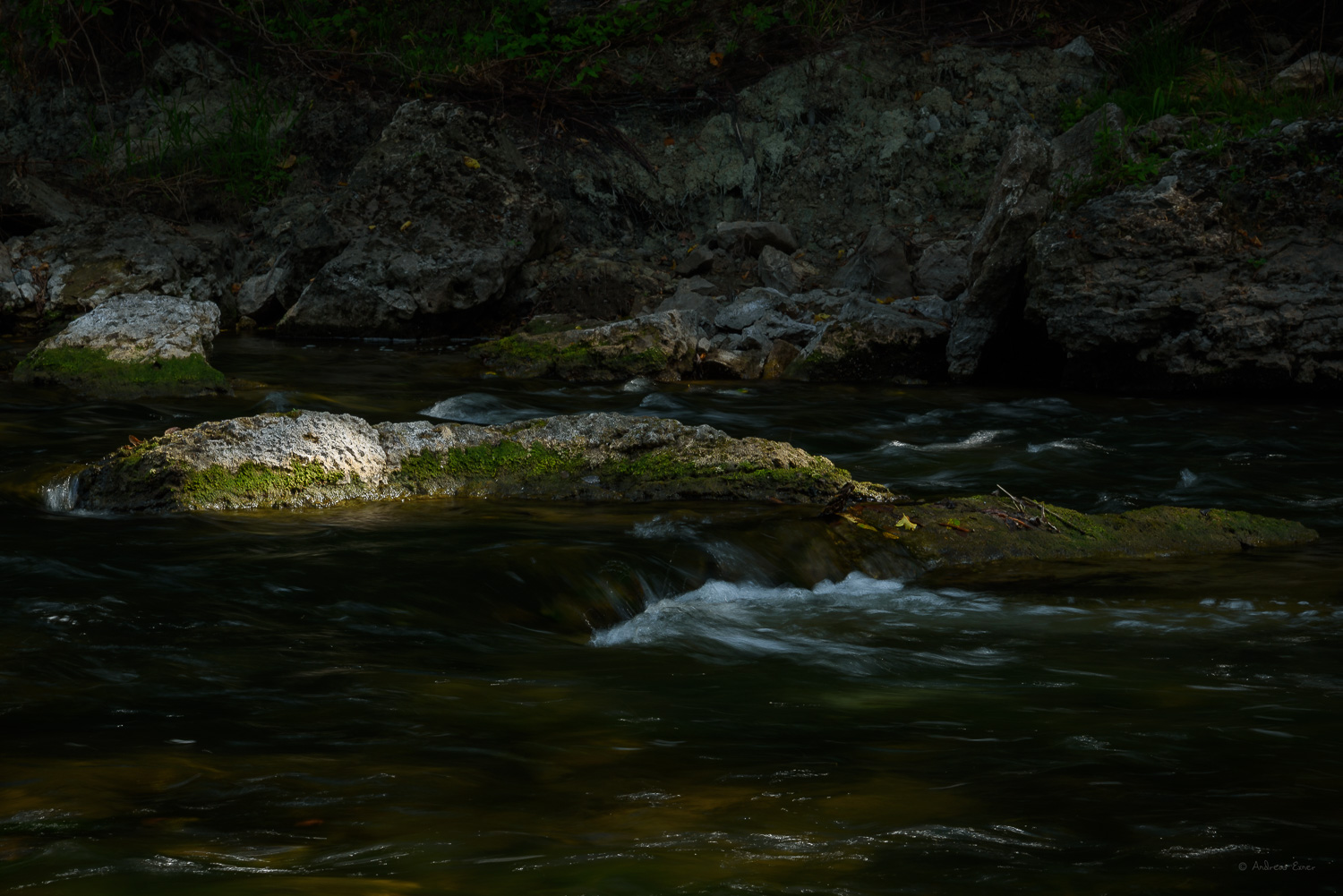 Shaft of light on a rock in the Volga River, Iowa -----