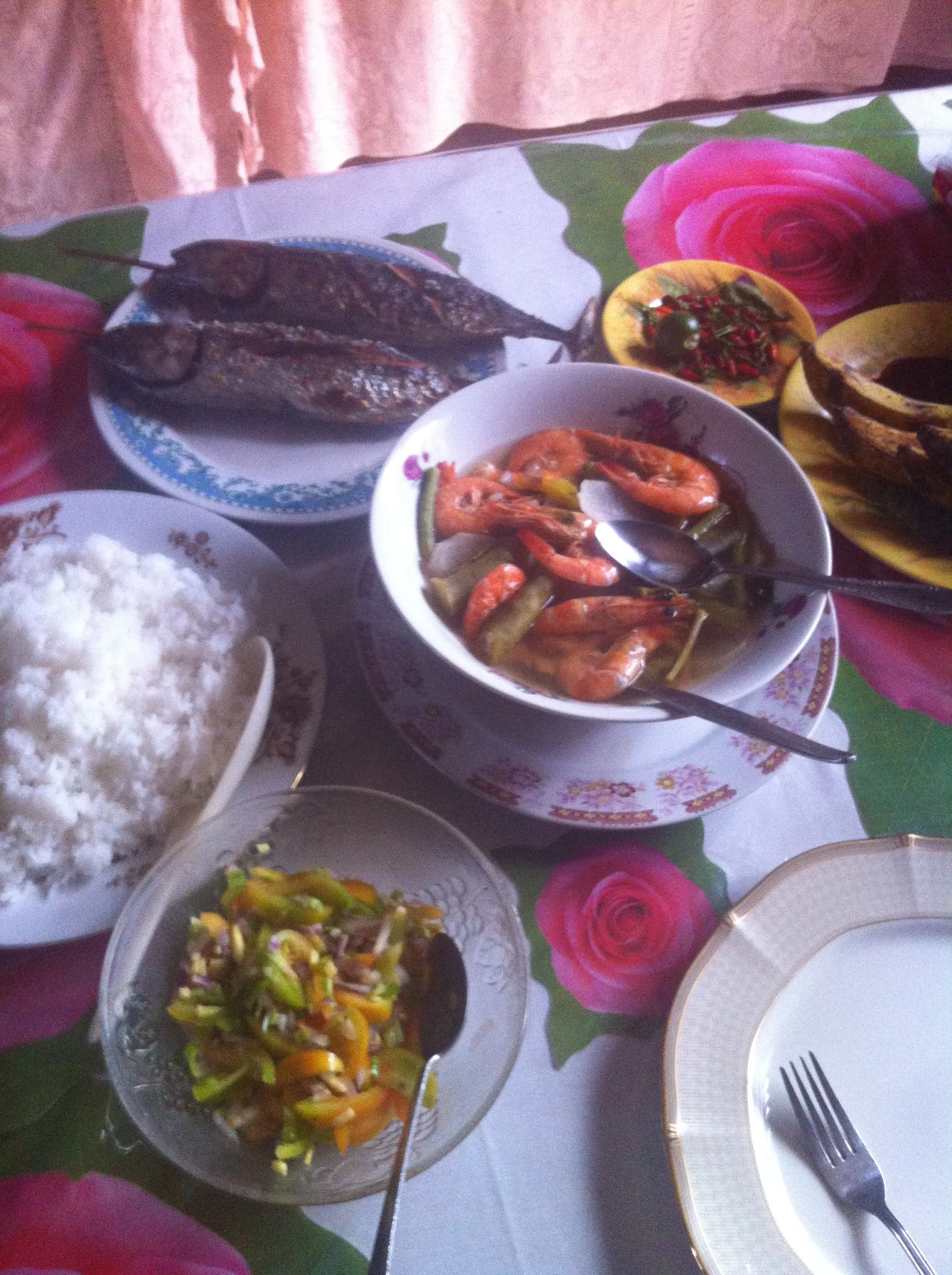 Lunch on the island of&nbsp;Negros Orientales: grilled fish, prawn sinigang, and tomato/ginger/chili salad. Yum!