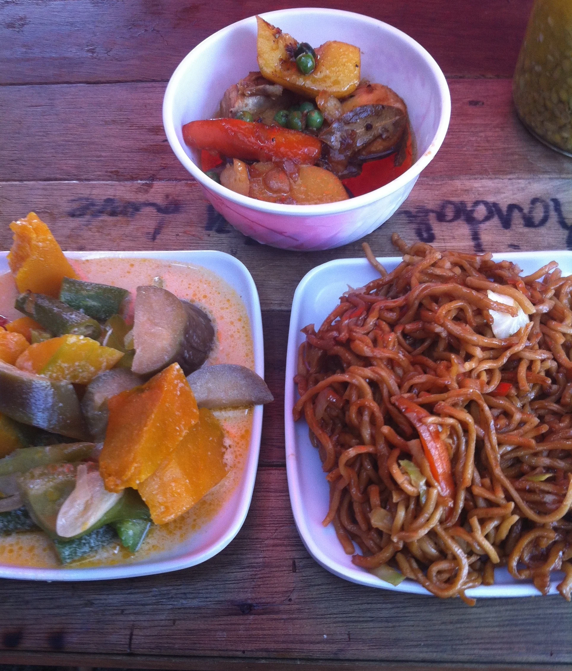 Street food in Manila, including chicken adobo (top), pancit canton (the noodles) and veggies cooked in coconut milk